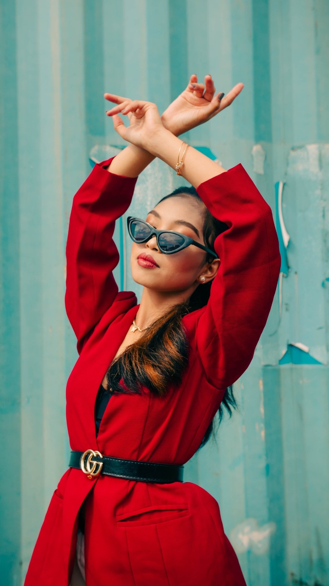 Model in red coat with sunglasses 