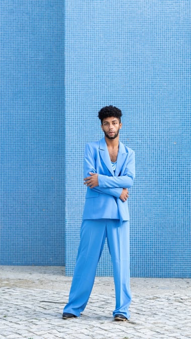 male model in a loose fit light blue suit 