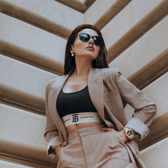 female woman in business suit with sunglasses and gold watch