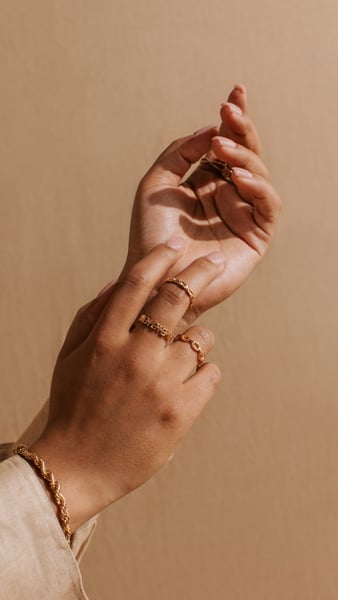 models hands facing the camera, with rings and bracelets 
