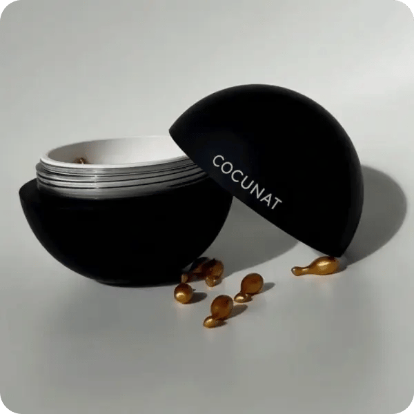 Black Cocunat container with gold Cocunat beads out of the container