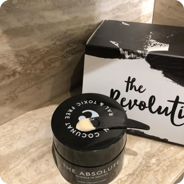 Black jar of Cocunat cream on a brown countertop