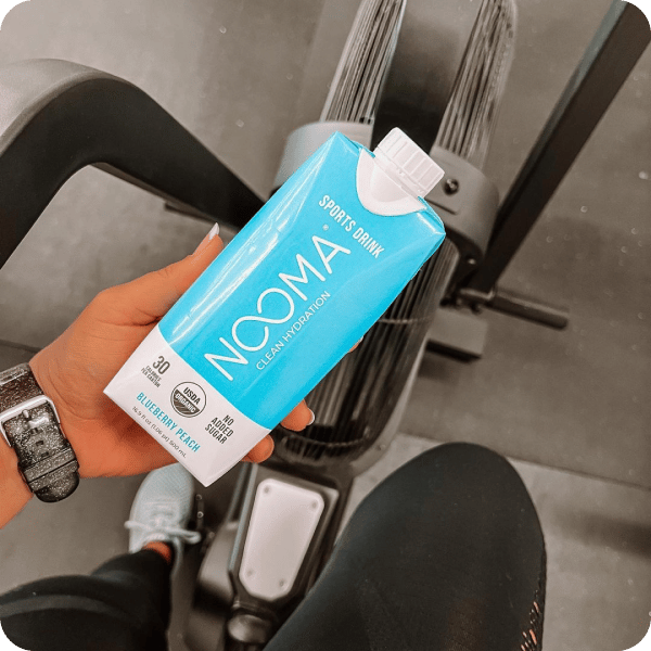 Nooma sports drink taken by a woman in the gym